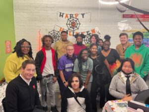 Kids and adults at a halloween party for LGBTQ youth