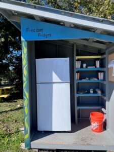 Outdoor Fridge at East White Oak Community Center below a sign that says "Freedom Fridges"