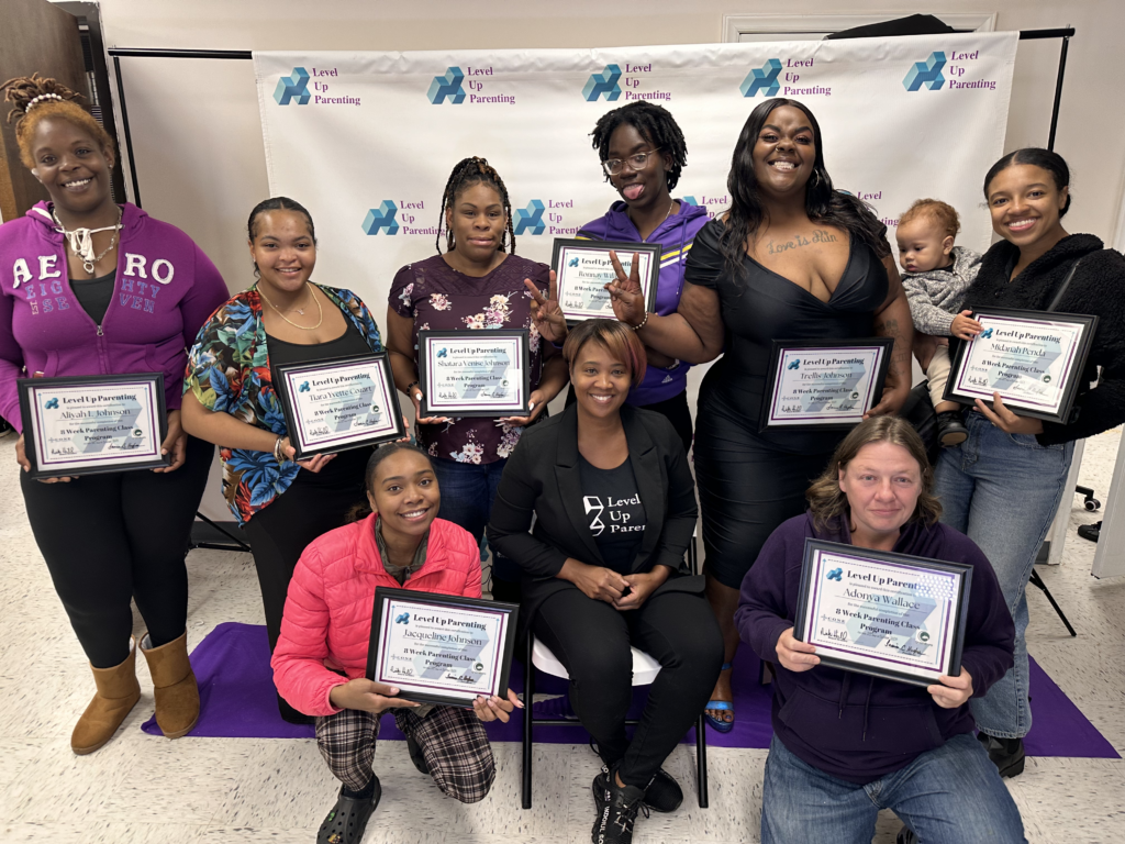 Group of people holding Level Up Parenting Certificates at Level Up Parenting Event