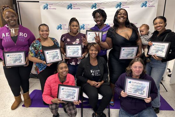 Group of people holding Level Up Parenting Certificates at Level Up Parenting Event
